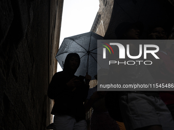 Tourists and locals walk through the city on a rainy September morning in Barcelona, Spain, on September 4, 2024. These first two weeks of S...