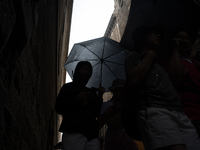 Tourists and locals walk through the city on a rainy September morning in Barcelona, Spain, on September 4, 2024. These first two weeks of S...