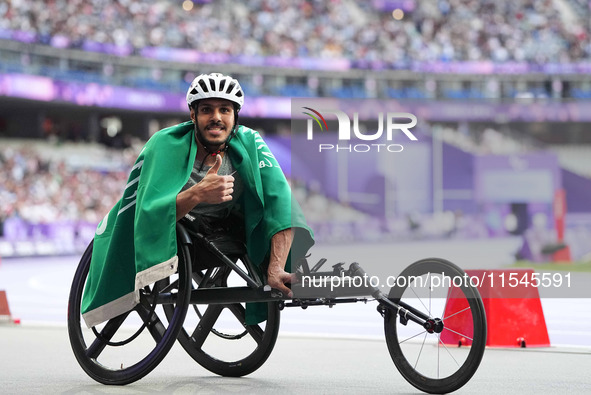 Adbulrahman Alqurashi of Saudi Arabia celebrates winning gold in Men's 100m - T53 Final during the Paris 2024 Paralympic Games at Stade de F...