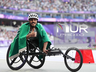 Adbulrahman Alqurashi of Saudi Arabia celebrates winning gold in Men's 100m - T53 Final during the Paris 2024 Paralympic Games at Stade de F...