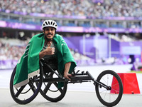 Adbulrahman Alqurashi of Saudi Arabia celebrates winning gold in Men's 100m - T53 Final during the Paris 2024 Paralympic Games at Stade de F...