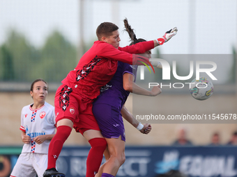 Roksana Shahanska, goalkeeper of Crvena Zvezda, punches the ball ahead of Amelie Delabre of Anderlecht during the UEFA Women's Champions Lea...