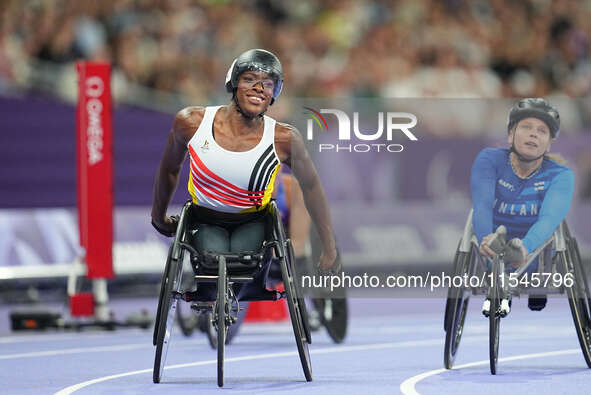 Lea Bayekula of Belgium celebrates winning gold in Women's 100m - T54 Final during the Paris 2024 Paralympic Games at Stade de France on Sep...