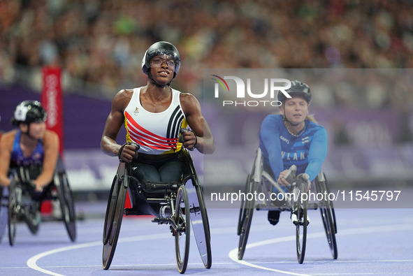 Lea Bayekula of Belgium celebrates winning gold in Women's 100m - T54 Final during the Paris 2024 Paralympic Games at Stade de France on Sep...