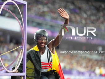 Lea Bayekula of Belgium celebrates winning gold in Women's 100m - T54 Final during the Paris 2024 Paralympic Games at Stade de France on Sep...