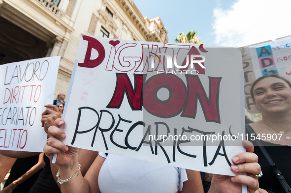 Temporary teachers, support teachers, and parents of disabled children demonstrate in front of the Ministry of Education and Merit against p...