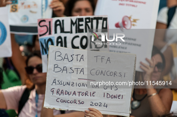 Temporary teachers, support teachers, and parents of disabled children demonstrate in front of the Ministry of Education and Merit against p...