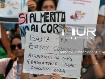 Temporary teachers, support teachers, and parents of disabled children demonstrate in front of the Ministry of Education and Merit against p...