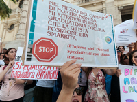 Temporary teachers, support teachers, and parents of disabled children demonstrate in front of the Ministry of Education and Merit against p...