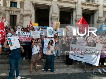 Temporary teachers, support teachers, and parents of disabled children demonstrate in front of the Ministry of Education and Merit against p...