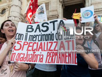 Temporary teachers, support teachers, and parents of disabled children demonstrate in front of the Ministry of Education and Merit against p...