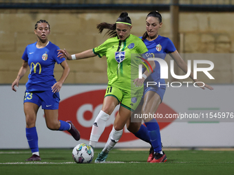 Tatjana Osmajic of Breznica is closely followed by Gabriella Zahra of Birkirkara during the UEFA Women's Champions League First qualifying r...