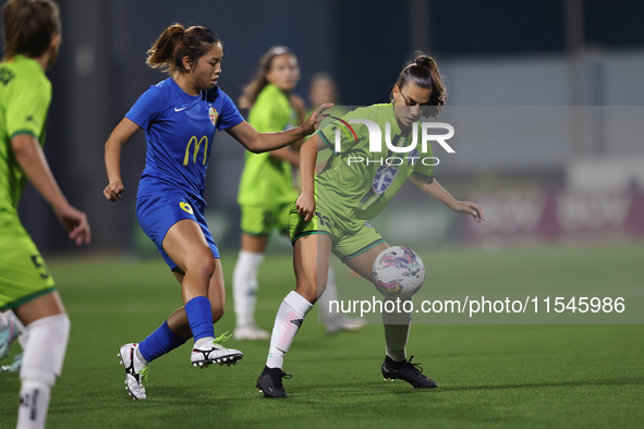 Milijana Pavlovic (R) of Breznica is closely followed by Yuna Hazekawa (L) of Birkirkara during the UEFA Women's Champions League First qual...