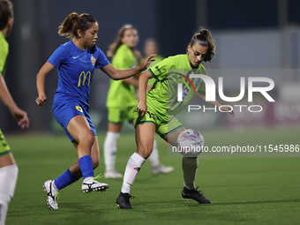 Milijana Pavlovic (R) of Breznica is closely followed by Yuna Hazekawa (L) of Birkirkara during the UEFA Women's Champions League First qual...