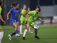 Milijana Pavlovic (R) of Breznica is closely followed by Yuna Hazekawa (L) of Birkirkara during the UEFA Women's Champions League First qual...