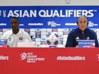 Qatar national team head coach Marquez Lopez (R) and player Moez Al Ali (L) attend a press conference at Ahmad Bin Ali Stadium in Al Rayyan,...