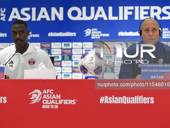 Qatar national team head coach Marquez Lopez (R) and player Moez Al Ali (L) attend a press conference at Ahmad Bin Ali Stadium in Al Rayyan,...