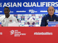 Qatar national team head coach Marquez Lopez (R) and player Moez Al Ali (L) attend a press conference at Ahmad Bin Ali Stadium in Al Rayyan,...