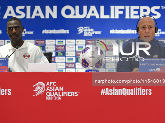 Qatar national team head coach Marquez Lopez (R) and player Moez Al Ali (L) attend a press conference at Ahmad Bin Ali Stadium in Al Rayyan,...