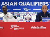 Qatar national team head coach Marquez Lopez (R) and player Moez Al Ali (L) attend a press conference at Ahmad Bin Ali Stadium in Al Rayyan,...