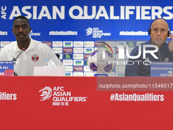 Qatar national team head coach Marquez Lopez (R) and player Moez Al Ali (L) attend a press conference at Ahmad Bin Ali Stadium in Al Rayyan,...