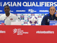 Qatar national team head coach Marquez Lopez (R) and player Moez Al Ali (L) attend a press conference at Ahmad Bin Ali Stadium in Al Rayyan,...