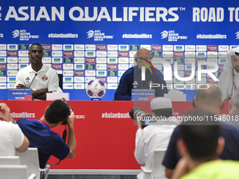 Qatar national team head coach Marquez Lopez (C) and player Moez Al Ali (L) attend a press conference at Ahmad Bin Ali Stadium in Al Rayyan,...