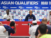 Qatar national team head coach Marquez Lopez (C) and player Moez Al Ali (L) attend a press conference at Ahmad Bin Ali Stadium in Al Rayyan,...