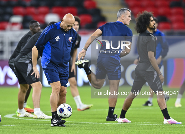 Head coach Marquez Lopez (L) of the Qatar national team attends a training session at Ahmad Bin Ali Stadium in Al Rayyan, Qatar, on Septembe...