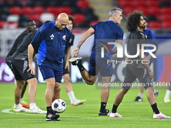 Head coach Marquez Lopez (L) of the Qatar national team attends a training session at Ahmad Bin Ali Stadium in Al Rayyan, Qatar, on Septembe...