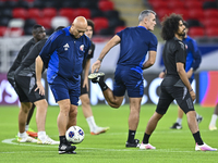 Head coach Marquez Lopez (L) of the Qatar national team attends a training session at Ahmad Bin Ali Stadium in Al Rayyan, Qatar, on Septembe...