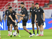 Mohammad Waad (C), Sultan Al Brake (L), and Bassam Al Rawi (R) from the Qatar National football team attend a training session at Ahmad Bin...