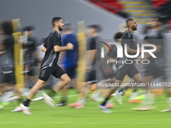 Mohammad Waad (L) and Abdulaziz Hatem (R) from the Qatar National football team attend a training session at Ahmad Bin Ali Stadium in Al Ray...