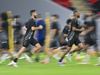 Mohammad Waad (L) and Abdulaziz Hatem (R) from the Qatar National football team attend a training session at Ahmad Bin Ali Stadium in Al Ray...