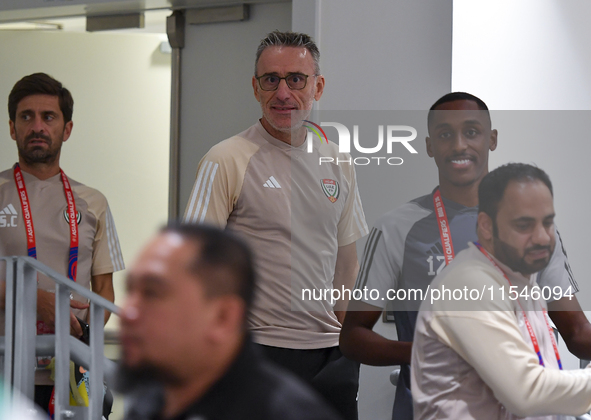 United Arab Emirates national team Head coach Paulo Bento (C) and player Khalifa Al Hammadi (R) arrive for the press conference at Ahmad Bin...