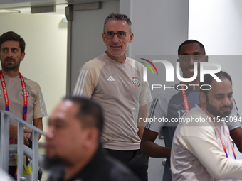 United Arab Emirates national team Head coach Paulo Bento (C) and player Khalifa Al Hammadi (R) arrive for the press conference at Ahmad Bin...