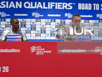 United Arab Emirates national team Head coach Paulo Bento (R) and player Khalifa Al Hammadi (L) attend a press conference at Ahmad Bin Ali S...