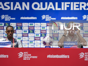 United Arab Emirates national team Head coach Paulo Bento (R) and player Khalifa Al Hammadi (L) attend a press conference at Ahmad Bin Ali S...