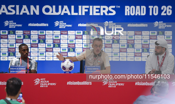 United Arab Emirates national team Head coach Paulo Bento (C) and player Khalifa Al Hammadi (L) attend a press conference at Ahmad Bin Ali S...