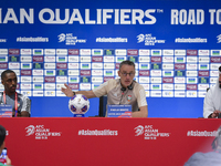 United Arab Emirates national team Head coach Paulo Bento (C) and player Khalifa Al Hammadi (L) attend a press conference at Ahmad Bin Ali S...