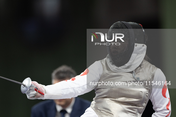 Rong Xiao of China and Beatrice Maria ''Bebe'' Vio Grandis of Italy compete during the Women's Foil Category B Semifinal at Gran Palais duri...