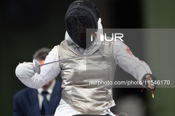 Rong Xiao of China and Beatrice Maria ''Bebe'' Vio Grandis of Italy compete during the Women's Foil Category B Semifinal at Gran Palais duri...