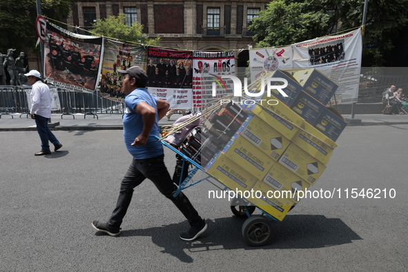 A merchant carries his products outside the Supreme Court of Justice of the Nation in Mexico City, Mexico, on September 4, 2024, where a wor...