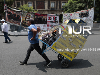 A merchant carries his products outside the Supreme Court of Justice of the Nation in Mexico City, Mexico, on September 4, 2024, where a wor...