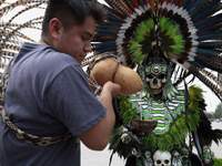 A pre-Hispanic dancer drinks pulque outside the Supreme Court of Justice of the Nation in Mexico City, Mexico, on September 4, 2024, where a...