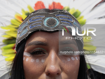 A pre-Hispanic dancer stands outside the Supreme Court of Justice of the Nation in Mexico City, Mexico, on September 4, 2024, where a work s...