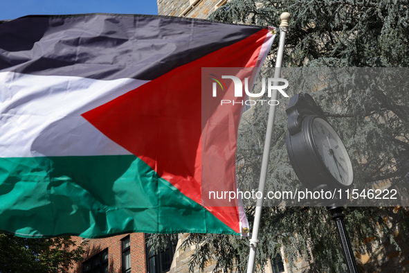 A Palestinian flag waves near a clock in Georgetown University's Red Square in Washington, D.C. durung a pro-Palestine demonstration on Sept...