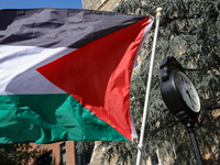 A Palestinian flag waves near a clock in Georgetown University's Red Square in Washington, D.C. durung a pro-Palestine demonstration on Sept...