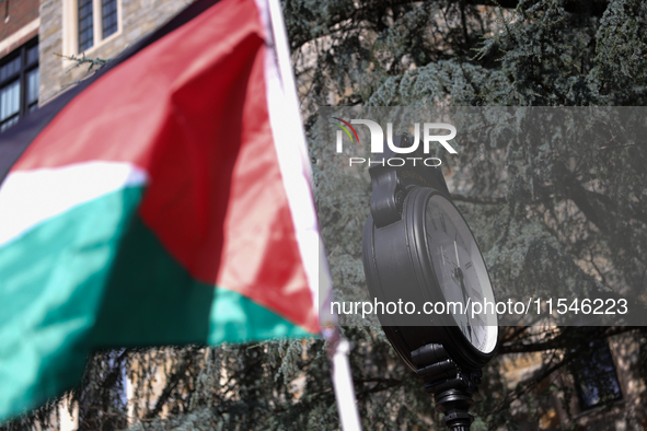 A Palestinian flag waves near a clock in Georgetown University's Red Square in Washington, D.C. durung a pro-Palestine demonstration on Sept...