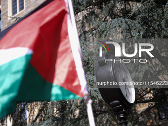 A Palestinian flag waves near a clock in Georgetown University's Red Square in Washington, D.C. durung a pro-Palestine demonstration on Sept...